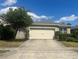 Charming home featuring a two-car garage and a well-manicured lawn at 219 Duke Dr, Deland, FL 32724