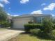 Well-maintained single-story home with a two-car garage and lush landscaping at 219 Duke Dr, Deland, FL 32724