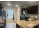 Well-lit kitchen featuring dark cabinetry and modern appliances at 219 Duke Dr, Deland, FL 32724
