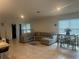 Open concept living room showcasing a large sectional couch and neutral decor at 219 Duke Dr, Deland, FL 32724