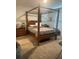 Bedroom with four poster bed frame, dresser and neutral carpet at 219 Duke Dr, Deland, FL 32724