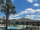 Community pool and clubhouse area surrounded by lounge chairs and lush landscaping at 219 Duke Dr, Deland, FL 32724