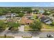 This aerial shows a well-kept home featuring a long driveway, screened in pool, and mature landscaping in a desirable neighborhood at 2289 Jessica Ln, Kissimmee, FL 34744