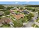 A birds eye view of a beautiful home with a screened pool, manicured lawns, and mature trees in a suburban setting at 2289 Jessica Ln, Kissimmee, FL 34744