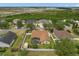 Aerial view shows a charming home with a screened pool, fenced yard, and mature trees in a Gathering-friendly community at 2289 Jessica Ln, Kissimmee, FL 34744