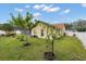 Spacious back yard featuring lush green grass, white fencing, and young trees, ideal for outdoor enjoyment at 2289 Jessica Ln, Kissimmee, FL 34744