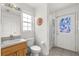 Bathroom featuring tiled floors, a door to the backyard, and vanity at 2289 Jessica Ln, Kissimmee, FL 34744