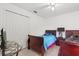 Cozy bedroom featuring twin beds, a ceiling fan, and ample closet space at 2289 Jessica Ln, Kissimmee, FL 34744