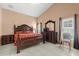 This bedroom has tile floors, large wooden furniture, and a vaulted ceiling at 2289 Jessica Ln, Kissimmee, FL 34744