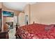 Bedroom featuring a large bed with red floral patterned linens at 2289 Jessica Ln, Kissimmee, FL 34744