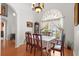 Elegant dining room with hardwood floors, chandelier, and a large arched window at 2289 Jessica Ln, Kissimmee, FL 34744
