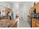 Modern kitchen with oak cabinetry, granite countertops, stainless steel appliances, and tile floors at 2289 Jessica Ln, Kissimmee, FL 34744