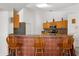 Kitchen featuring breakfast bar with seating, oak cabinets, granite counters, and stainless appliances at 2289 Jessica Ln, Kissimmee, FL 34744