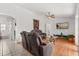 Well-lit living room with wood flooring, ceiling fan and comfortable seating area at 2289 Jessica Ln, Kissimmee, FL 34744