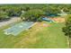 Overhead shot of community park featuring playground equipment, basketball court, and picnic area amidst green space at 2430 Mill Run Blvd, Kissimmee, FL 34744