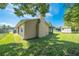 A well-maintained backyard featuring a storage shed, screened patio and lush green grass at 2430 Mill Run Blvd, Kissimmee, FL 34744