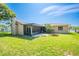 A screened patio and fire pit area are focal points in this backyard at 2430 Mill Run Blvd, Kissimmee, FL 34744