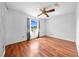 Spacious bedroom with a ceiling fan, wood floors, and a bright window view at 2430 Mill Run Blvd, Kissimmee, FL 34744