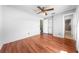 Bedroom with wood-look flooring, ceiling fan, and closet with sliding doors at 2430 Mill Run Blvd, Kissimmee, FL 34744