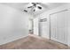 Bright bedroom with a ceiling fan, neutral carpet, and closet doors at 2430 Mill Run Blvd, Kissimmee, FL 34744