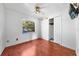 Bedroom featuring wood-look floors, a ceiling fan, and a bright window at 2430 Mill Run Blvd, Kissimmee, FL 34744