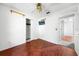 Bedroom showcasing wood-look floors, closet, ceiling fan, and mounted TV at 2430 Mill Run Blvd, Kissimmee, FL 34744