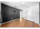 Bedroom featuring dark accent wall, closet, ceiling fan, and wood-look floors at 2430 Mill Run Blvd, Kissimmee, FL 34744
