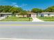 Charming home with a well-maintained front yard, mature tree, and inviting curb appeal, close to street at 2430 Mill Run Blvd, Kissimmee, FL 34744