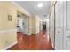 Inviting hallway with hardwood floors and views into the kitchen and front entrance at 2430 Mill Run Blvd, Kissimmee, FL 34744