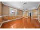 Spacious living room featuring hardwood floors, beadboard paneling, large window and decorative wallpaper at 2430 Mill Run Blvd, Kissimmee, FL 34744