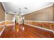 Traditional-style living room featuring hardwood floors, beadboard paneling, and decorative wallpaper at 2430 Mill Run Blvd, Kissimmee, FL 34744
