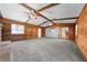 Bright living room with stone fireplace, wood-paneled walls, and ceiling beams at 2430 Mill Run Blvd, Kissimmee, FL 34744