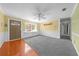 Inviting living room with a large window, wood floors, and neutral carpeting at 2430 Mill Run Blvd, Kissimmee, FL 34744