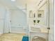 Well-lit bathroom featuring a shower and tub combination, modern fixtures, and laminate flooring at 2611 Gala N Rd # 101, Kissimmee, FL 34746