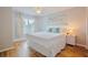 Bright bedroom features a ceiling fan, wood floors, and two windows with neutral-colored curtains at 2611 Gala N Rd # 101, Kissimmee, FL 34746
