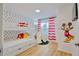 Fun bedroom with bunk beds, Mickey Mouse wall decor, and a window with striped curtains at 2611 Gala N Rd # 101, Kissimmee, FL 34746