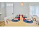 Open-concept dining area with a wooden table, six chairs, and laminate flooring at 2611 Gala N Rd # 101, Kissimmee, FL 34746