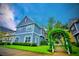 Two-story blue and grey home with red shutters, lush green lawn and manicured bushes at 2611 Gala N Rd # 101, Kissimmee, FL 34746