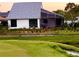 Picturesque view of a screened-in patio and well-manicured backyard with golf course views at 2615 Autumn Green Dr, Orlando, FL 32822