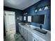 Bright bathroom with a contemporary design, featuring dual sinks, granite countertop, and modern fixtures at 2615 Autumn Green Dr, Orlando, FL 32822
