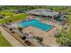 Aerial view of large community pool surrounded by lush landscaping and lounge chairs at 2615 Autumn Green Dr, Orlando, FL 32822