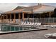 Inviting community pool surrounded by lounge chairs and a white fence with a building in the background at 2615 Autumn Green Dr, Orlando, FL 32822