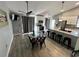 Cozy dining area with a modern glass table, kitchen island, and stylish pendant lighting at 2615 Autumn Green Dr, Orlando, FL 32822