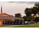 Several Golf carts lined up in a parking lot at dusk with an American flag nearby at 2615 Autumn Green Dr, Orlando, FL 32822