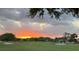 Scenic golf course view at sunset, featuring lush green fairways and mature trees at 2615 Autumn Green Dr, Orlando, FL 32822