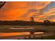A scenic view of the community golf course with sand traps and sunset at 2615 Autumn Green Dr, Orlando, FL 32822