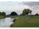 Picturesque view of a well-manicured golf course with a bridge and pond at 2615 Autumn Green Dr, Orlando, FL 32822