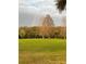 Beautiful golf course view with a rainbow after the rain, surrounded by lush green trees at 2615 Autumn Green Dr, Orlando, FL 32822