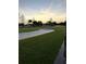 Golf course with sand trap, lush grass, palm trees, and clear skies at 2615 Autumn Green Dr, Orlando, FL 32822