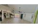 Open living room view featuring kitchen, sliding glass doors, and modern finishes at 2615 Autumn Green Dr, Orlando, FL 32822